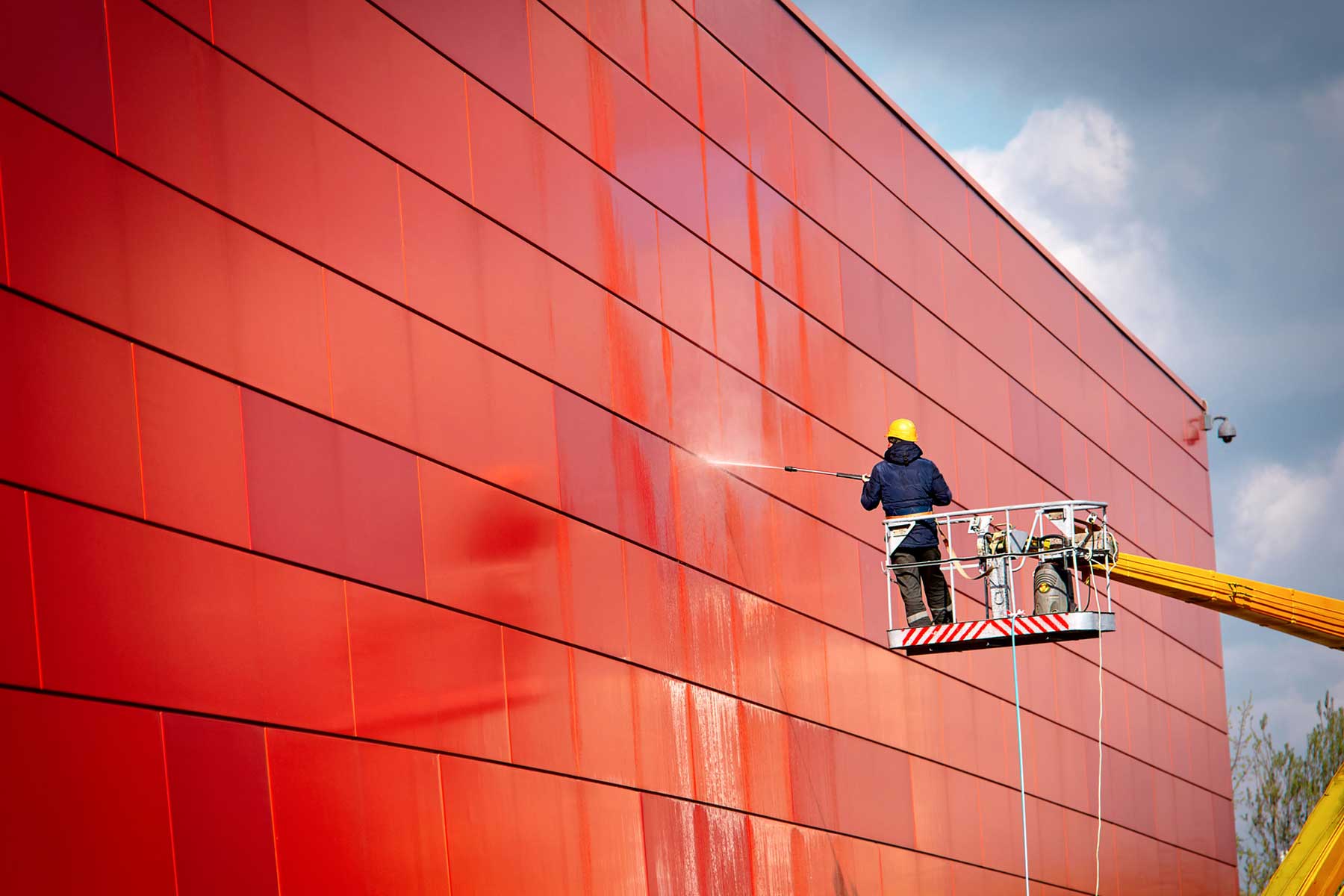 Pressure washing side of building